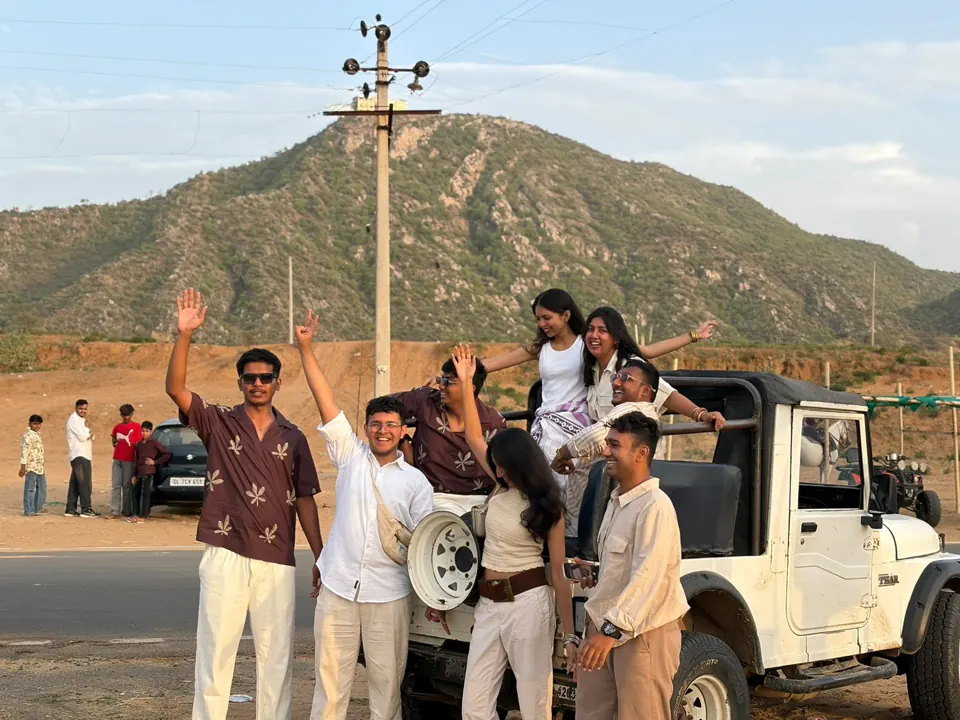 Guests gathering around their safari jeep in the Rajasthan landscape