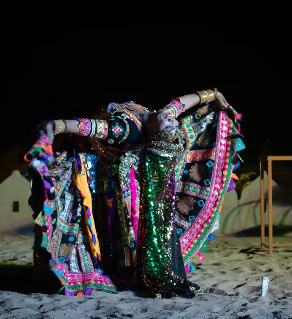 Folk dancer in an embroidered costume performing a traditional dance