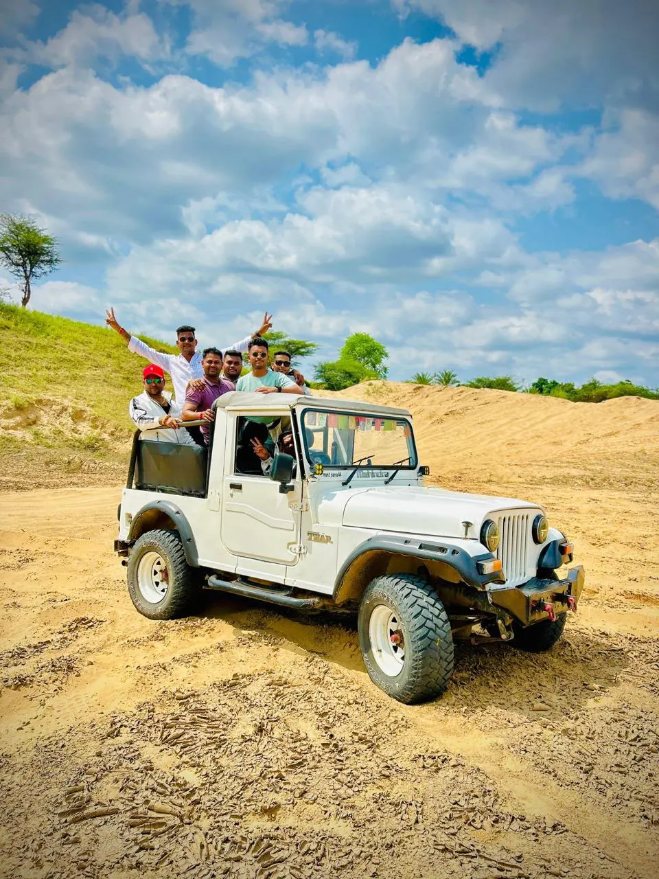 White safari jeep and guests on the sandy tracks of Pushkar