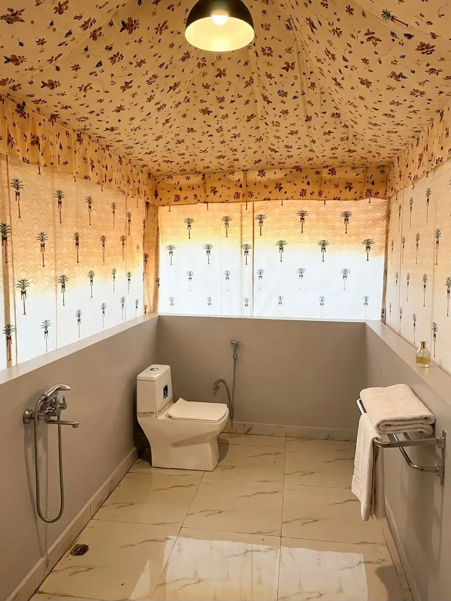 Tent washroom with a basin, toilet and shower area